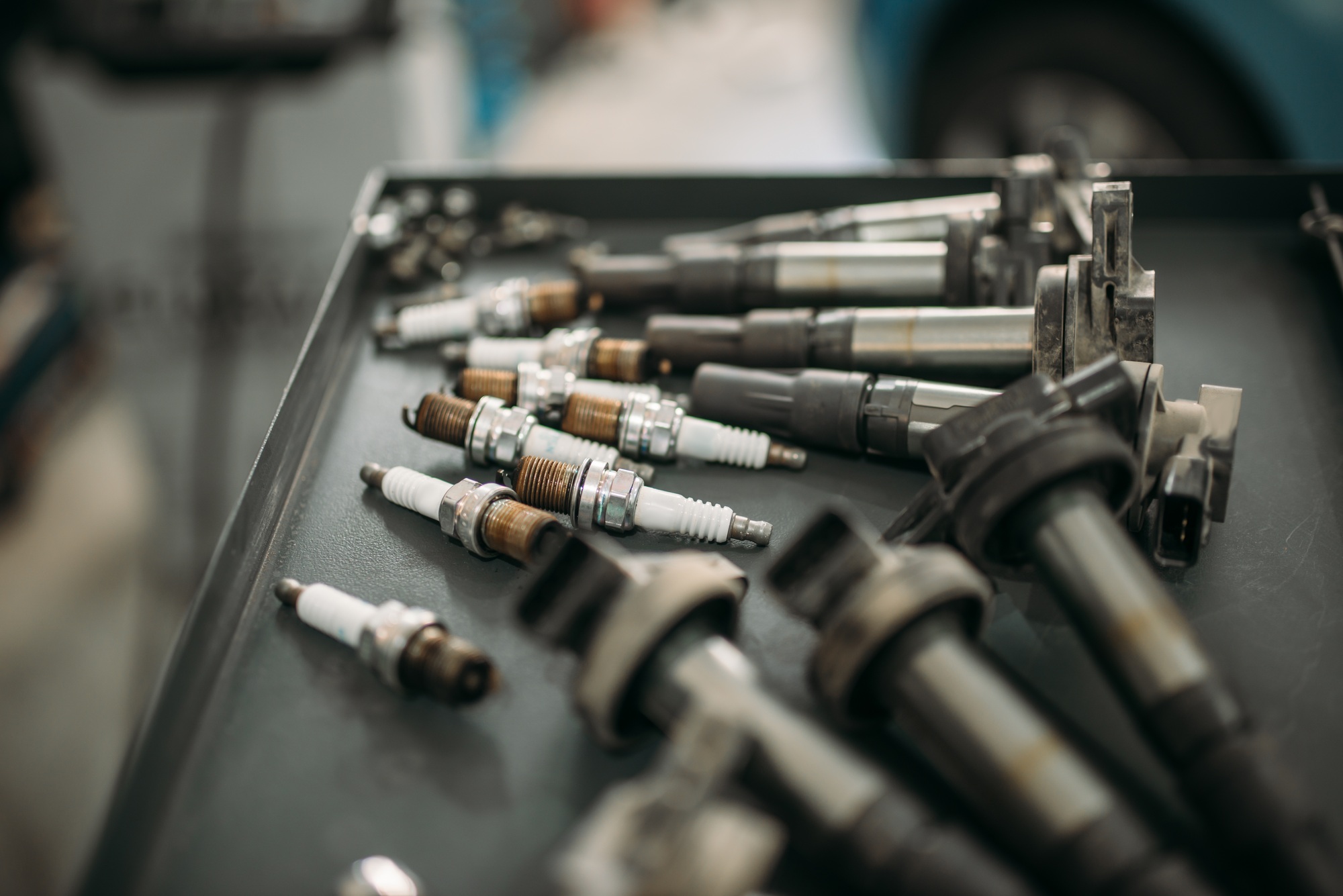 Spark plugs and ignition wires laid out on a workbench